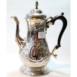 Silver coffee pot by Samuel Wood, 1760, of baluster shape embossed with flowerheads, scrolls and