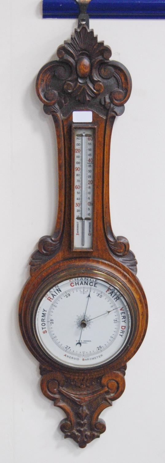 Edwardian oak banjo aneroid wall barometer with thermometer gauge above a circular dial, by T & E