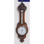 Edwardian oak banjo aneroid wall barometer with thermometer gauge above a circular dial, by T & E