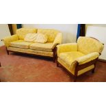 Double cane three-seater bergere sofa with matching armchair, upholstered in lemon floral fabric,