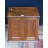Late Victorian oak collector's cabinet, the two panelled doors enclosing seven small drawers with