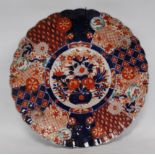 Japanese Meiji period Imari charger decorated with floral panels with a frilly rim, blue