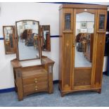 Early 20th century Arts & Crafts oak single door wardrobe with matching dressing chest, the wardrobe