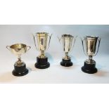 Four silver two-handled cups, with plinths, 516g.