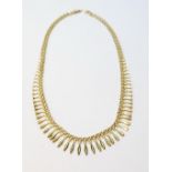 9ct gold fringe necklace of tapering baton links, 18g.