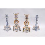 Two near-matching Rouen Faience candlesticks decorated with mythical masks and floral panels, 25cm