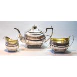 Silver three-piece tea set by Thomas Robins 1812, of ovoid boat shape with fluted corners,