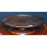 19th century mahogany revolving lazy susan, the saucer top on a turned base with circular foot, 11cm
