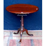 George III mahogany tripod table, the snap action circular tilt top on a birdcage and turned column,