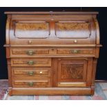 Late Victorian walnut cylinder desk, the fall front enclosing pigeon holes, two drawers and a pull-