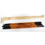 Japanese-style gadget bamboo fishing rod in eight sections with ebonised painted shaft and tip,