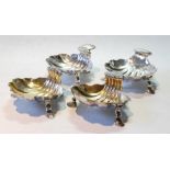 Set of four scallop dishes, probably late 18th century, with ribbed grips, two parcel gilt, upon pad