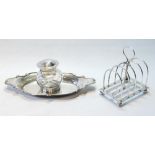 Silver inkstand by E Hutton, 1885, with mounted cut glass receiver, on waved oval base, 1902, and