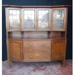 Early 20th century Arts & Crafts oak bookcase, the concave bookcase with four leaded glass doors