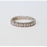 18ct white gold diamond half eternity ring with seven separated brilliants, size P.