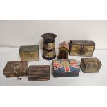 Eight antique biscuit tins and money boxes to include a Cadbury's Dairy Milk money box in the form