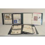 Three well filled world postage stamp albums comprising of first day cover coin sets. To include