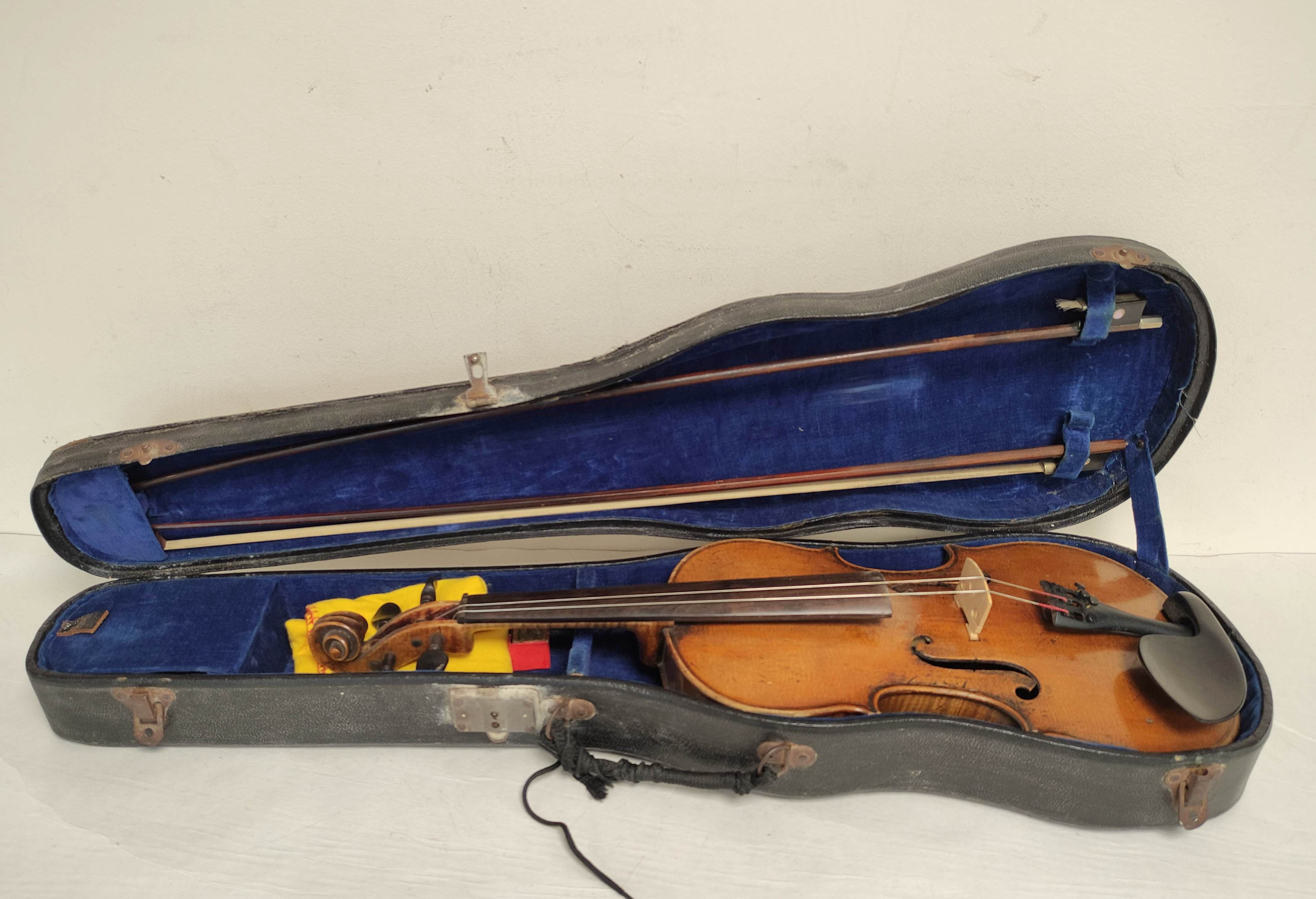 Antique 4/4 size violin with two piece maple back and spruce top. In fitted hard case with two