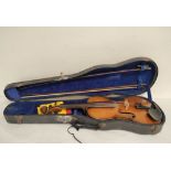 Antique 4/4 size violin with two piece maple back and spruce top. In fitted hard case with two