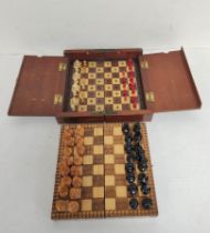 Two antique travel chess sets in wooden cases. One being a Victorian example with bone and wood