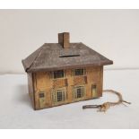 Antique 1920s advertisement biscuit tin money box in the form of a house. Printed on the roof is a