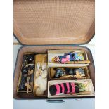 Suitcase containing a quantity of vintage Pelham Puppet animal marionettes to include Elephant