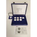 Collection of eight silver royal commemorative commonwealth coins in a plush velvet case with