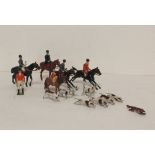 Collection of sixteen Britains Ltd lead painted foxhunting figures, which includes nine foxhounds.