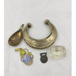 Collection of artifacts to include a Middle Eastern white metal bangle, a glass melon bead in the