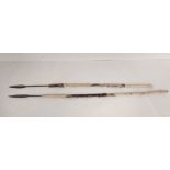 Two African assegai spears of crude iron construction with shafts wrapped with gazelle hides.