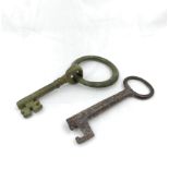 Two English Medieval keys, the largest of bronze construction measuring 14cms in length complete