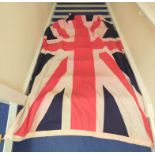 Two maritime ensign flags the largest being a United Kingdom Union Jack of canvas construction