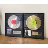Two framed music memorabilia of Robbie Williams, one gold plated The Ego has Landed, limited edition