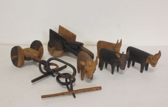 Vintage African carved hardwood figures depicting a team of oxen pulling a wagon.