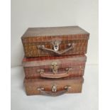 Three early 20th century novelty printed biscuit tins in the form of suitcases to include two