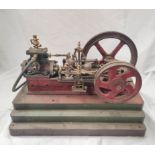 Early 20th century model steam engine of a single cylinder mill  engine on cast iron and wood