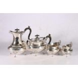 George V sterling silver four piece tea service, with ribbon and garland decorated body, raised on
