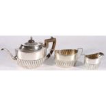 Victorian sterling silver three piece bachelor's tea service, with reeded body, Harrison Brother &