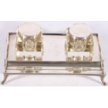 George V sterling silver desk stand of rectangular form on paw supports with two glass and silver