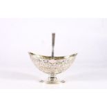 Antique sterling silver swing handled basket of navette shape with gilded interior and heavy foliate