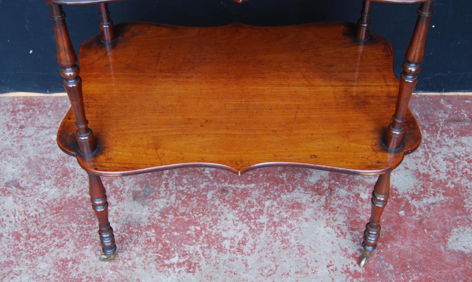 19th century mahogany window table, with two shaped tiers, on turned supports with brass castors, - Image 7 of 7