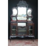 Edwardian mahogany drawing room cabinet, the tri-plate mirror top on a pierced scroll and shell