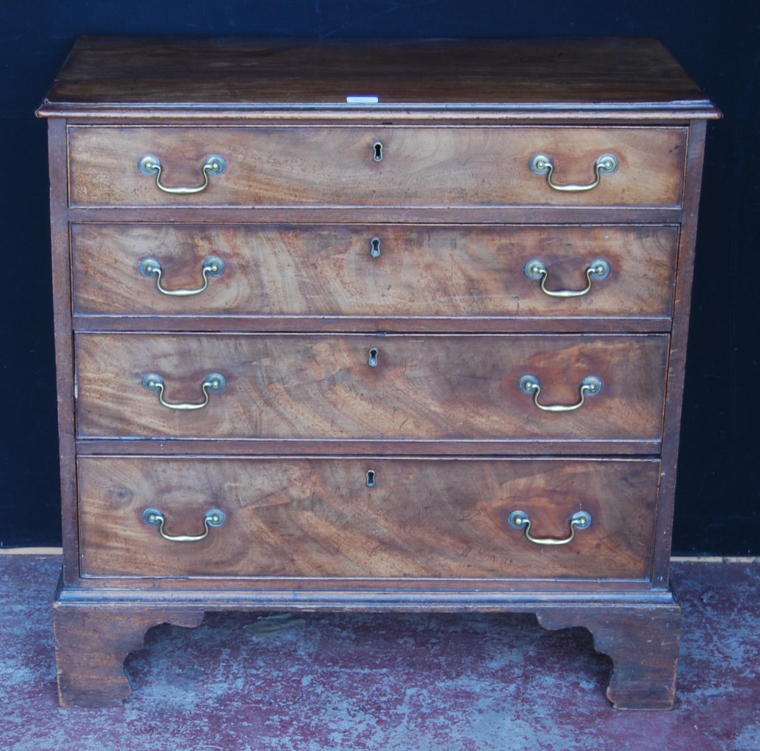 George III mahogany bachelor's chest of four graduated drawers, on bracket feet, 84cm high, 86cm