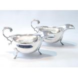 Pair of silver sauce boats of mid 18th century-style with scroll handles, by Hamilton & Inches,