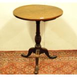 George III oak tripod table, the circular top on a turned column and tripod supports, 75cm high