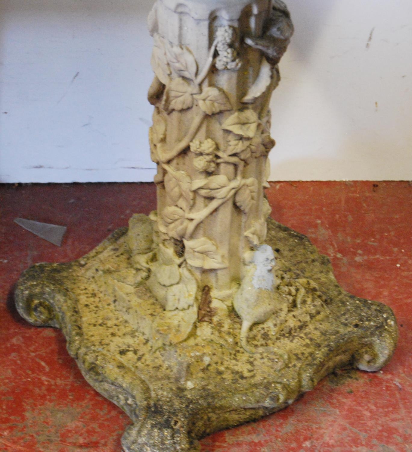 Stone garden bird bath decorated with a putti surmount to the open well, the cylindrical column with - Image 2 of 4