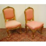 Pair of Louis XV style giltwood parlour chairs decorated with moulded roses, floral panels and
