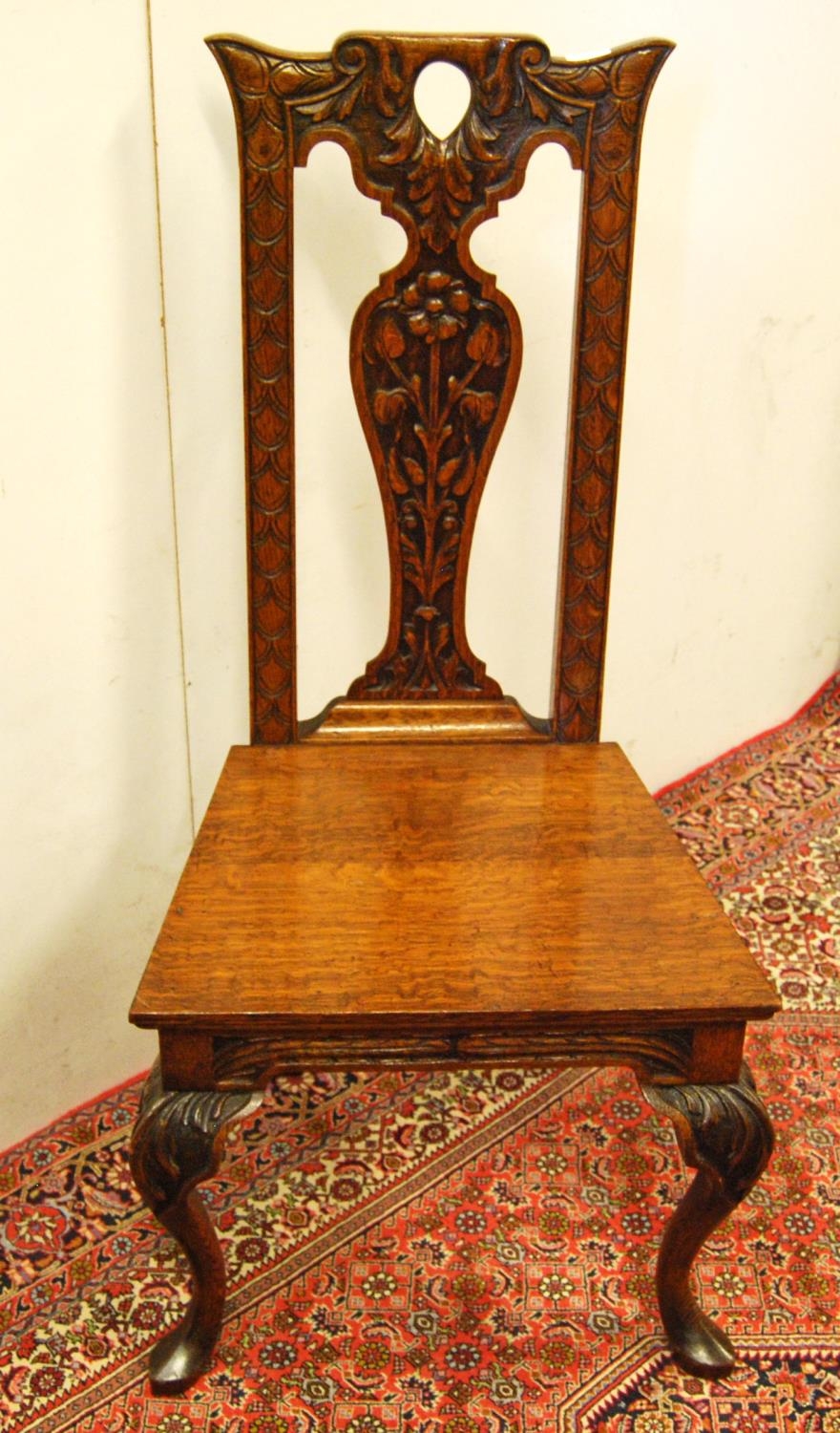 Early 20th century carved oak hall chair, the shaped top above a fiddle-shaped back rest carved with - Image 2 of 3