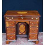George III style inlaid mahogany kneehole desk, the long drawer above a cupboard door