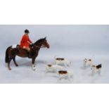 Beswick porcelain hunting group comprising a huntsman on horseback with five hounds.  (6)